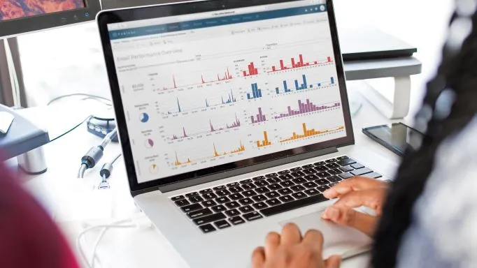 A laptop showing a business intelligence dashboard